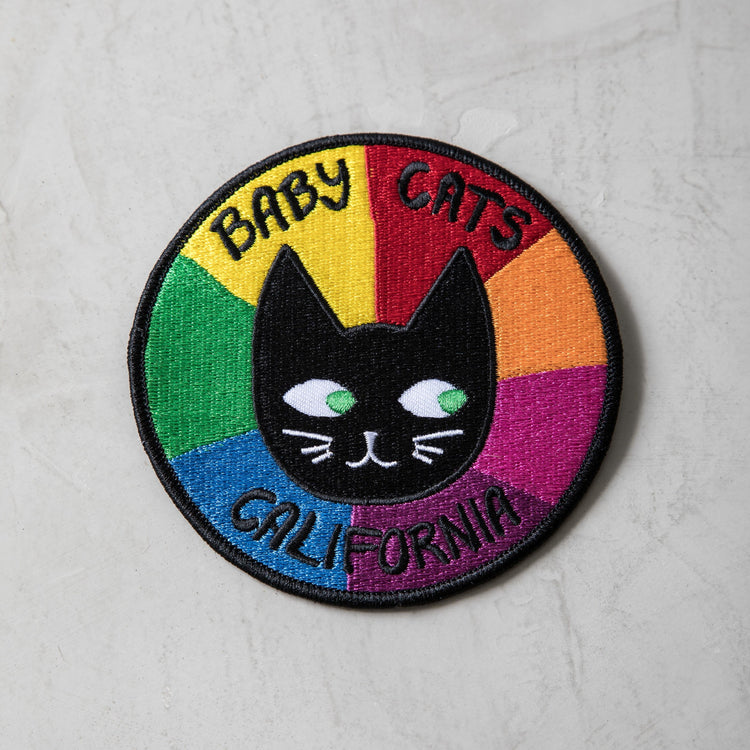 Cat Patch with a black cat face and colorful rainbow segments labeled Baby Cats California on a round embroidered patch