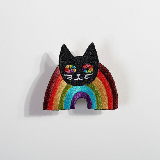 Rainbow Cat Patch with black cat head and colorful rainbow stripes on an embroidered fabric accessory